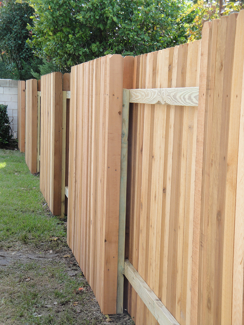 Alternating section wooden fence with white vertical planks