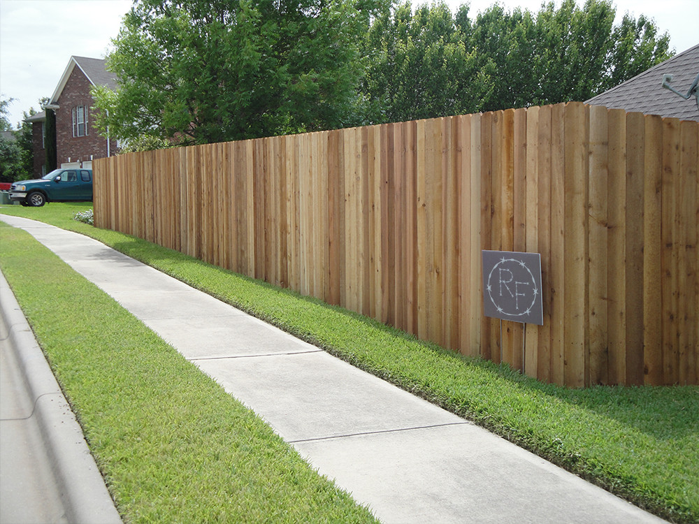 Wooden fence next to a sidewalk