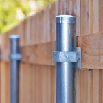 Closeup of steel posts on a wooden fence