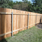 Backyard wooden fence with steel posts