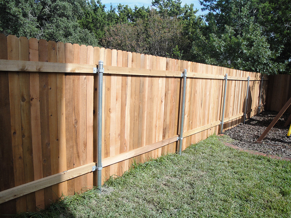 Backyard wooden fence with steel posts